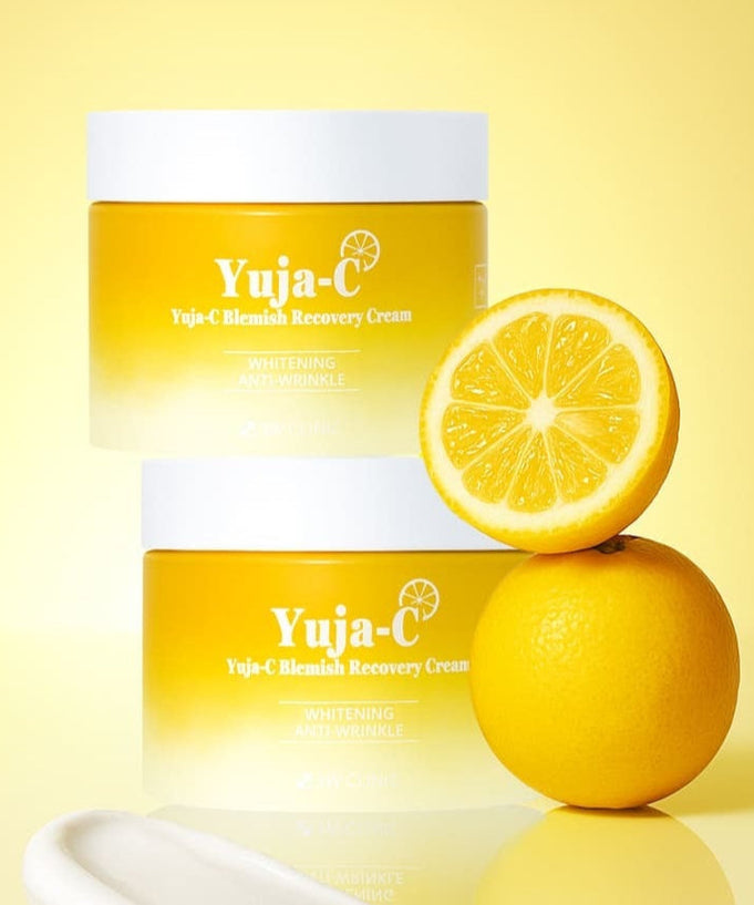 3W CLINIC Yuja Seed Blemish Recovery Cream 110g jars with fresh yuja fruit on a bright yellow background.