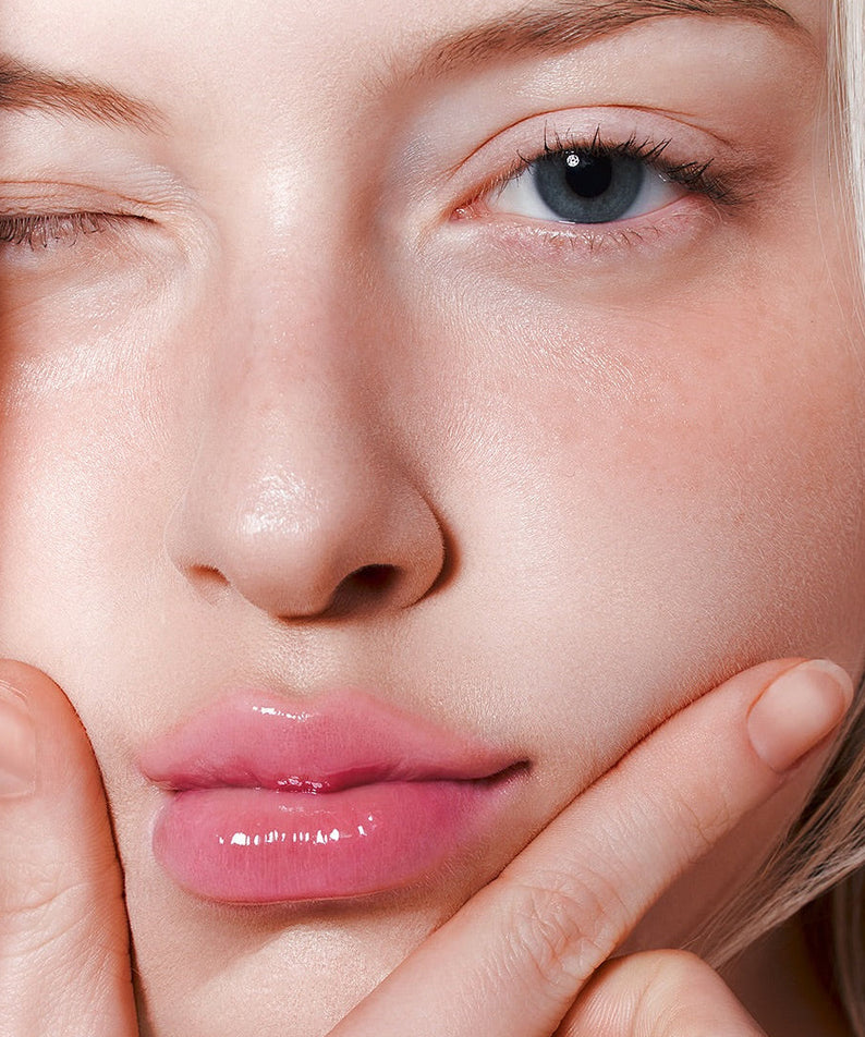 Woman applying MILK TOUCH Glow Up Collagen Lip Balm 15g for plump, glossy lips