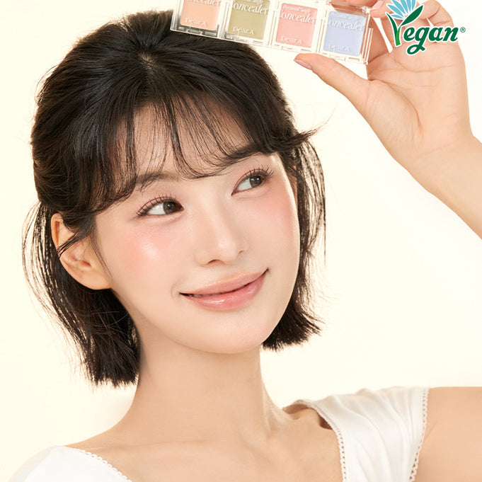Woman holding DEAR.A Single Concealer 10 Colors with vegan logo.
