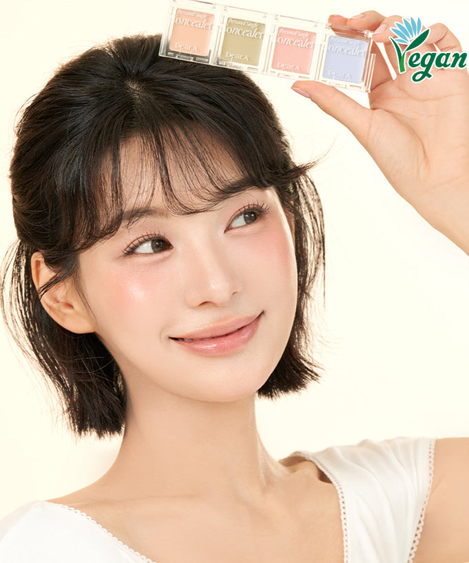 Woman holding DEAR.A Single Concealer 10 Colors with vegan logo.