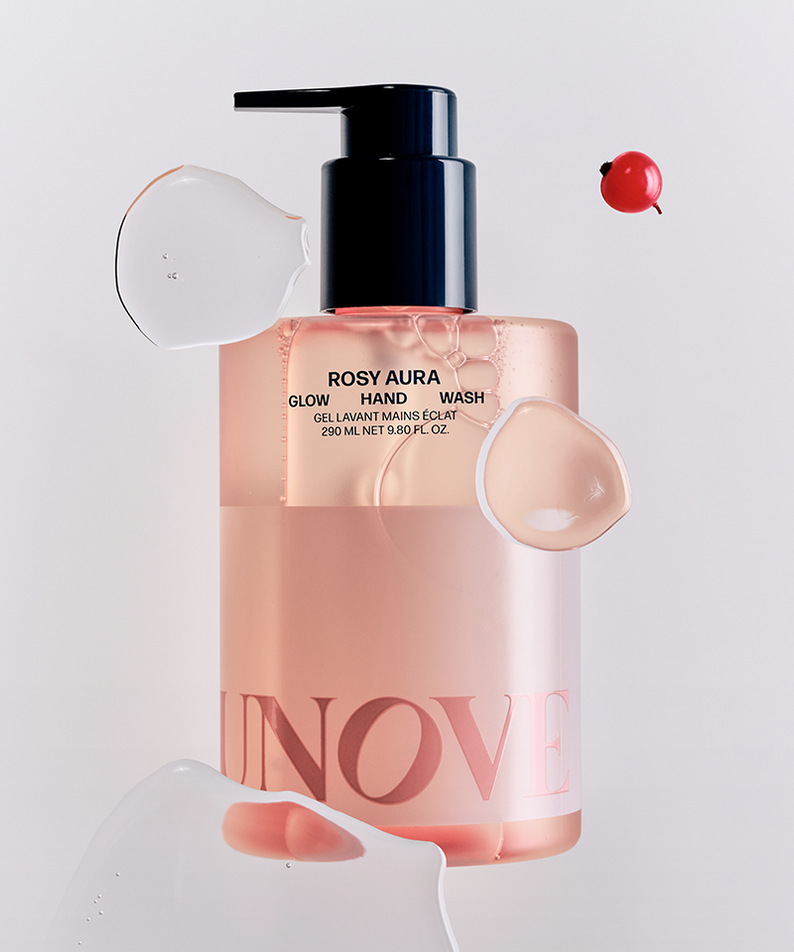 UNOVE Glow Hand Wash 290ml bottle with liquid splashes and decorative elements, highlighting its elegant packaging.