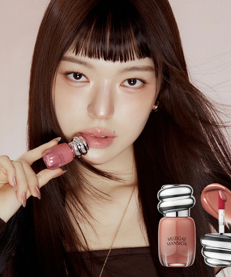 MUZIGAE MANSION Rainbow Mansion Object Glossy Mini 1.8g product held by model with lip gloss application