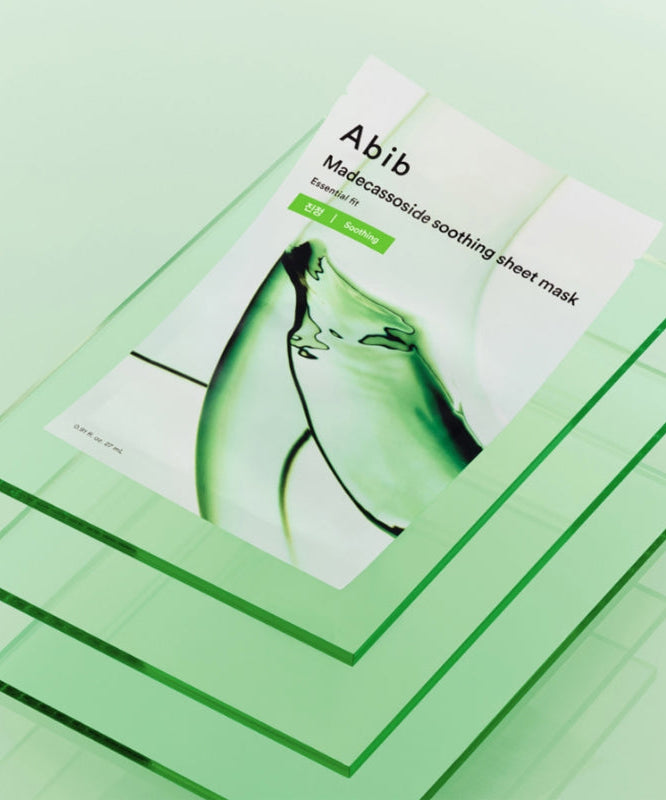 ABIB Madecassoside Soothing Sheet Essential Fit displayed on green glass layers