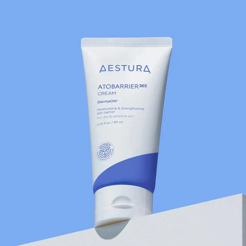 AESTURA Atobarrier 365 Cream 80ml tube on display against a blue background.