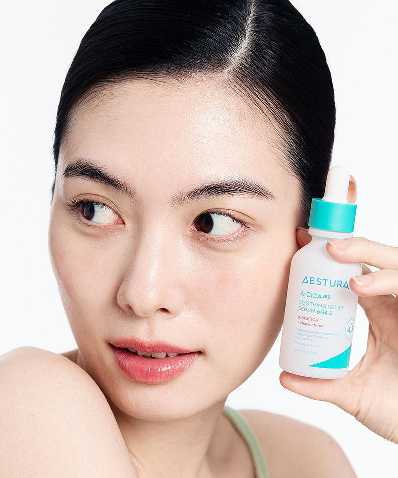 Woman holding AESTURA A-cica 365 Soothing Relief Serum pH4.5 40ml bottle for skincare