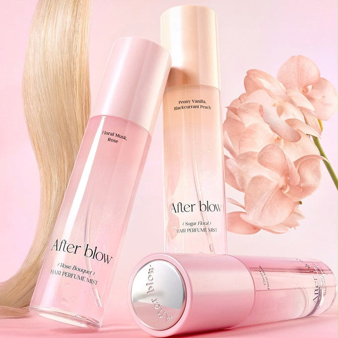 AFTER BLOW Hair Perfume Mist 80ml in pink bottles with flowers, showcasing floral fragrances for hair.