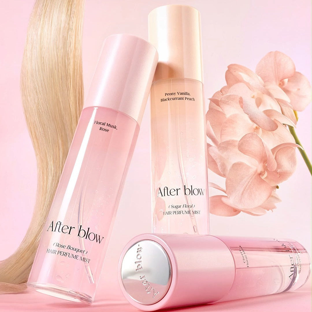AFTER BLOW Hair Perfume Mist 80ml in pink bottles with flowers, showcasing floral fragrances for hair.