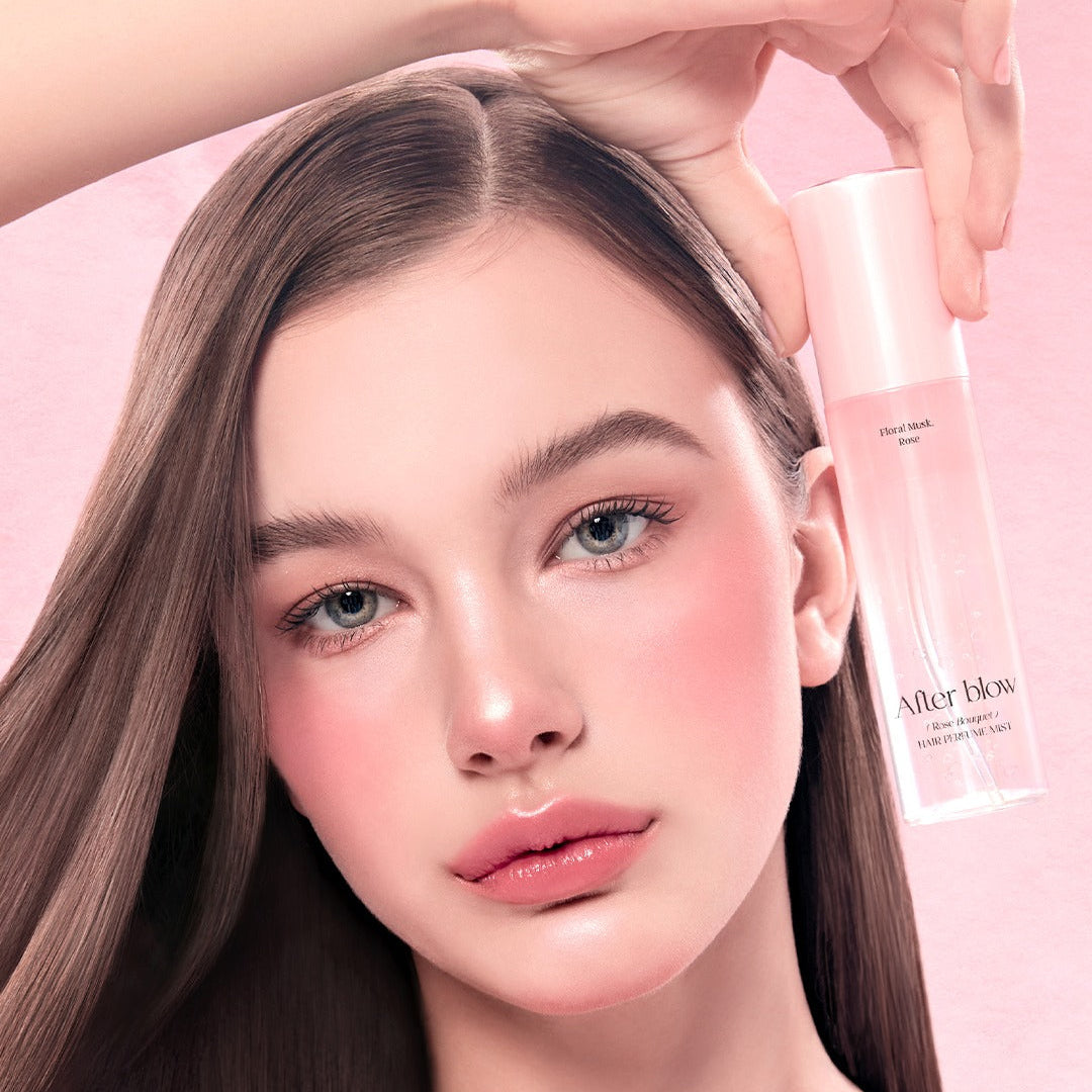 Model holding AFTER BLOW Hair Perfume Mist 80ml, showcasing vibrant and radiant hair with the product.