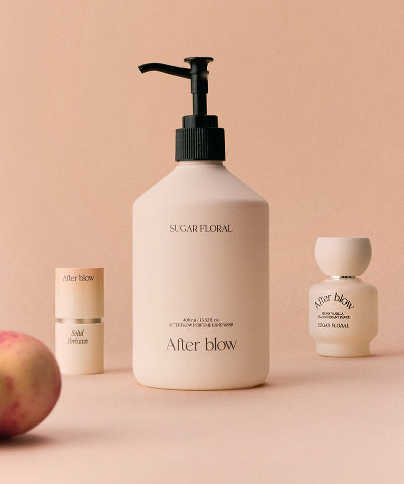 AFTER BLOW Perfume Hand Wash Sugar Floral 400ml bottle with additional fragrance products on a peach background
