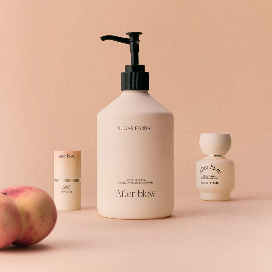 AFTER BLOW Perfume Hand Wash Sugar Floral 400ml bottle with additional fragrance products on a peach background