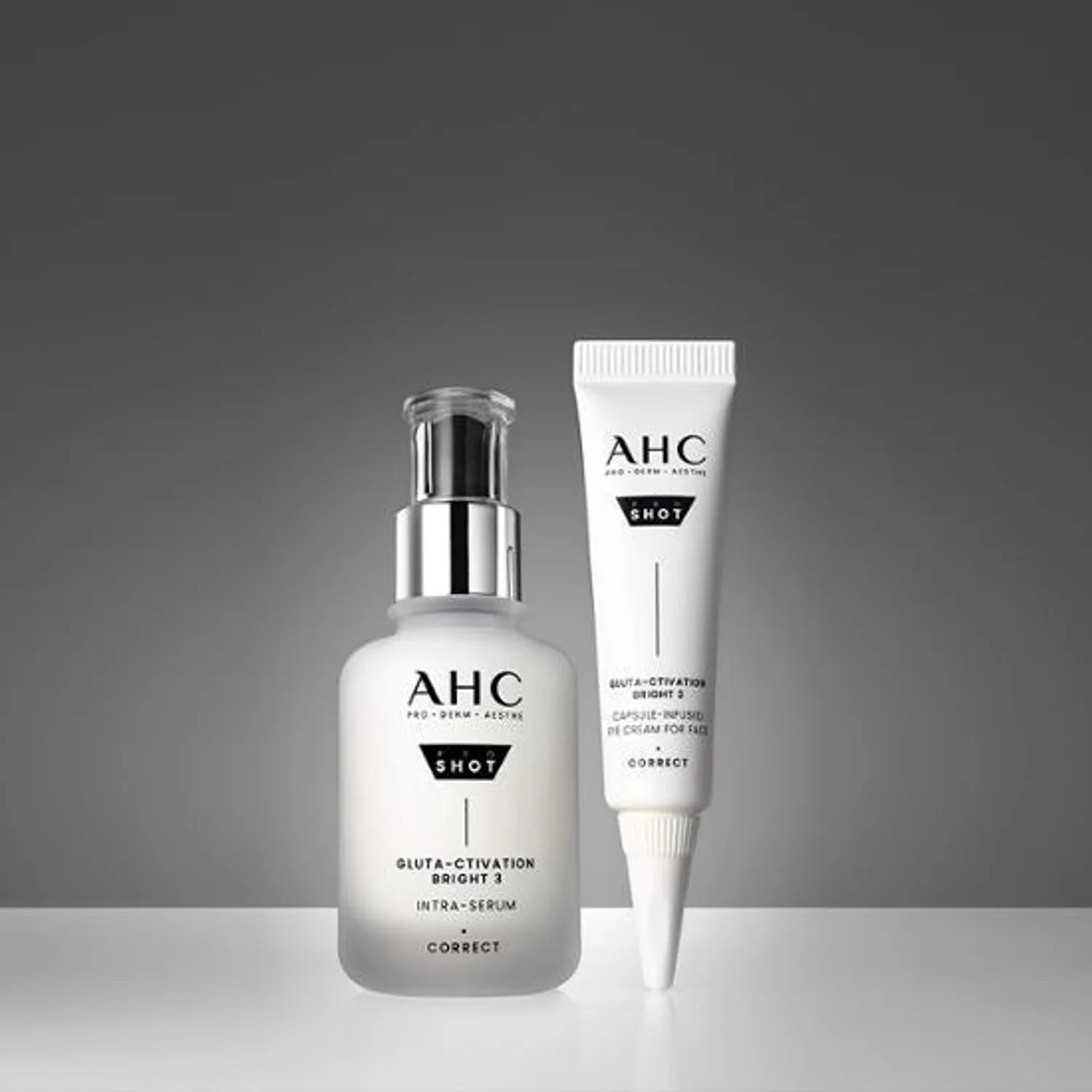 AHC Pro Shot Gluta Activation Bright 3 Intra Serum 40ml bottle and tube on a grey background.