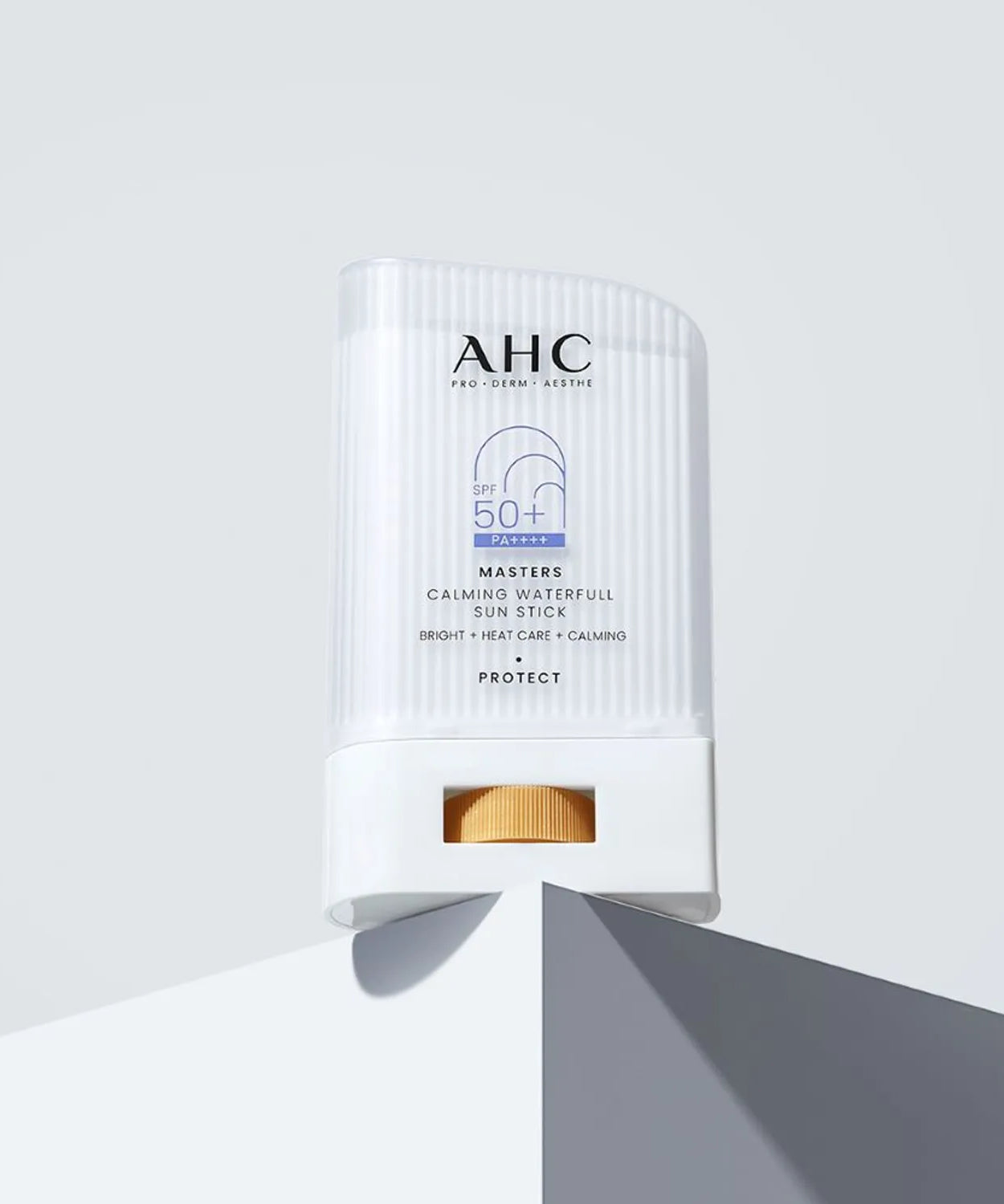 AHC Masters Calming Waterfull Sun Stick 22g placed on a white surface for protection from sun damage.