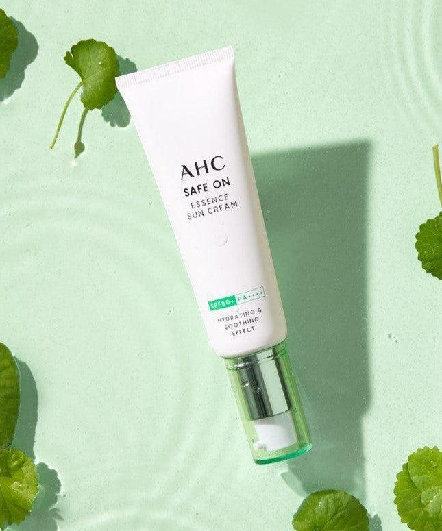 AHC Safe On Essence Sunscreen 50ml displayed on a green leaf background, highlighting its hydrating formula.