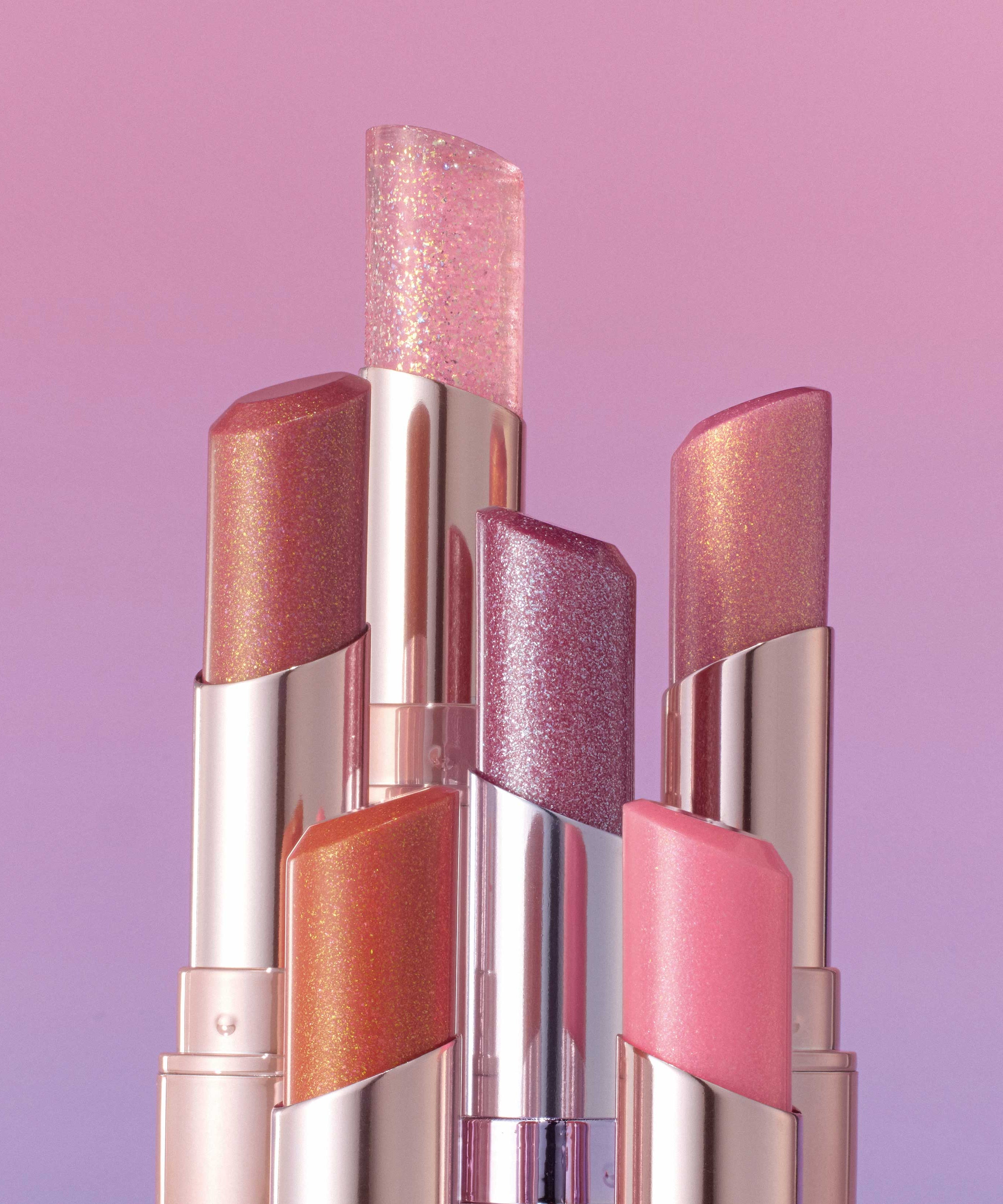 ALL MY THING I'm Your Lip Tint collection in various shades and shimmering finishes against a pink gradient background.