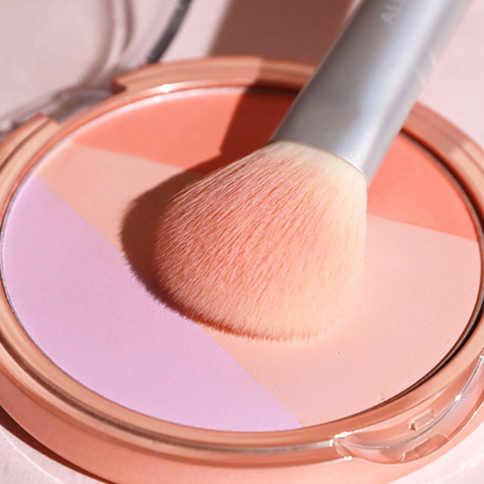 ALL MY THING Aurora Blusher in a compact with a makeup brush on top, showcasing its vibrant shades.