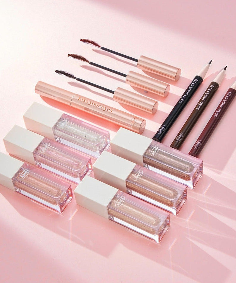 ALL MY THING Kiss Your Eye Glitter Liquid Eyeshadow collection with mascaras and eyeliners on a pink background