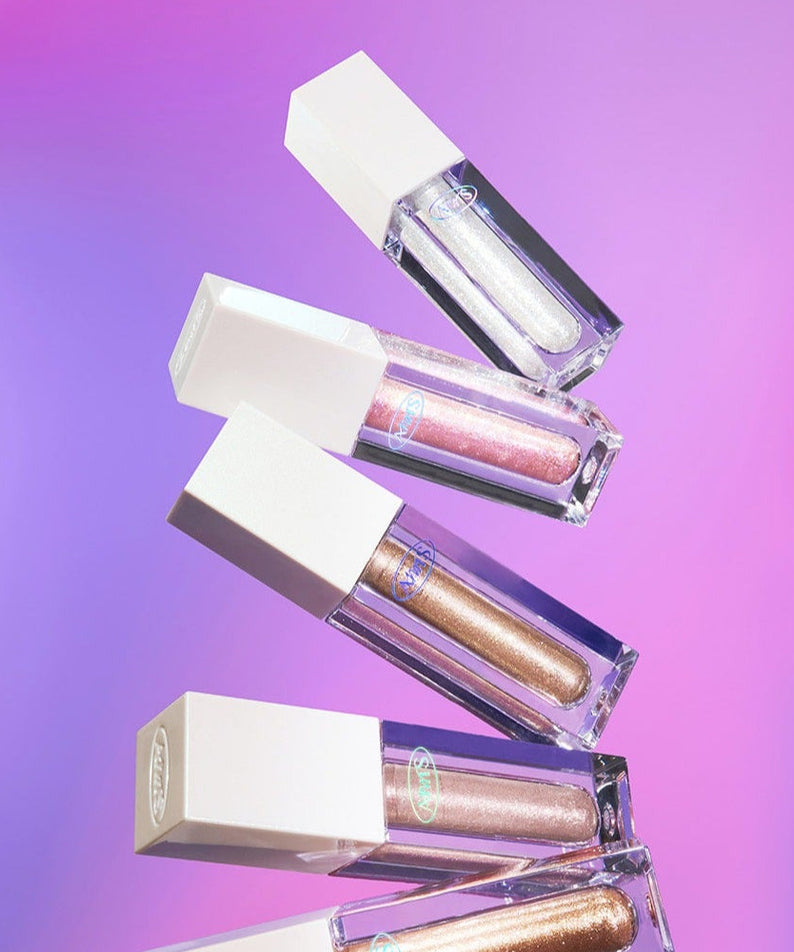 ALL MY THING Kiss Your Eye Glitter Liquid Eyeshadow variety on display against pink and purple gradient background