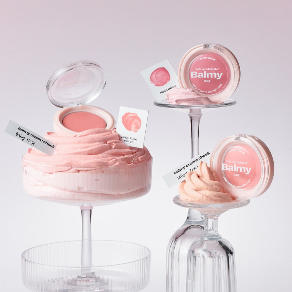 ALTERNATIVE STEREO Balmy Cream Cheek in elegant packaging, displayed on glass stands against a soft pink background.