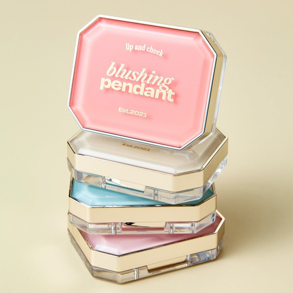 Stack of ALTERNATIVE STEREO Blushing Pendant Lip & Cheeck compacts in various colors, showcasing elegant design and luxurious finish.