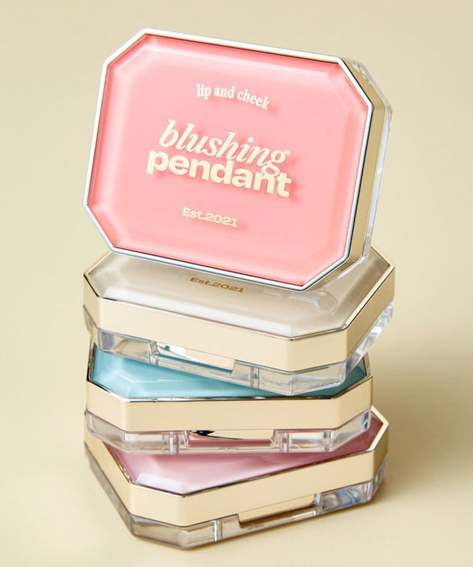 Stack of ALTERNATIVE STEREO Blushing Pendant Lip & Cheeck compacts in various colors, showcasing elegant design and luxurious finish.