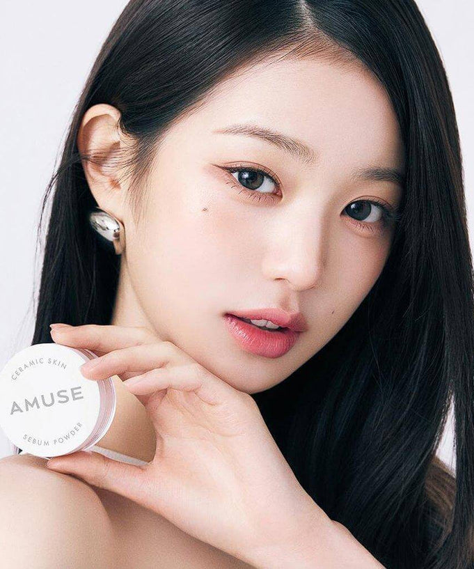Model holding AMUSE Ceramic Sebum Powder, highlighting smooth and matte skin effect.