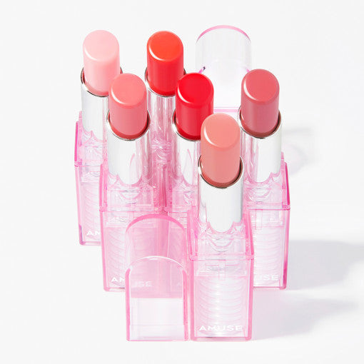 AMUSE Dew Balm collection of colorful lip balms in pink cases for vibrant, hydrating lips.