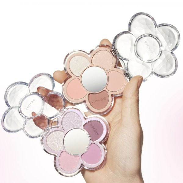 AMUSE Flora Eye Palette in flower-shaped case with multiple shades shown in hand.