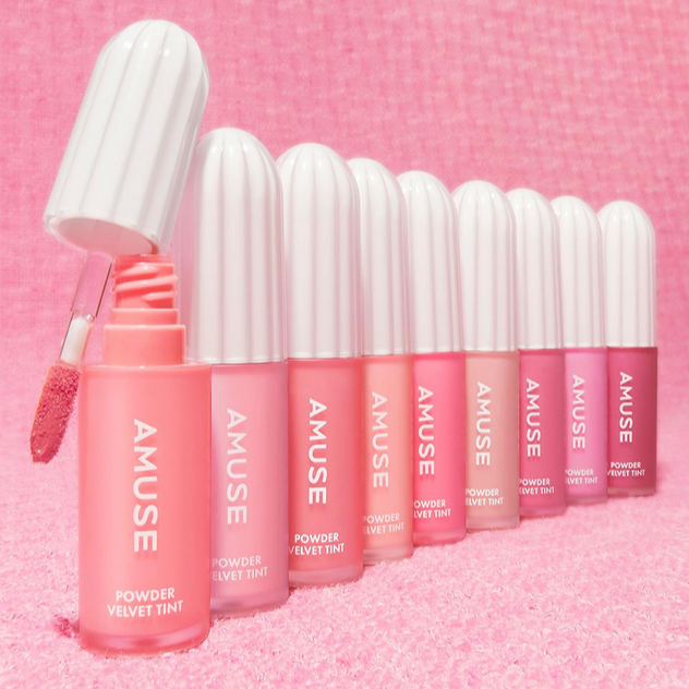 AMUSE Powder Velvet Tint lip collection showcasing a variety of vibrant shades with applicator.