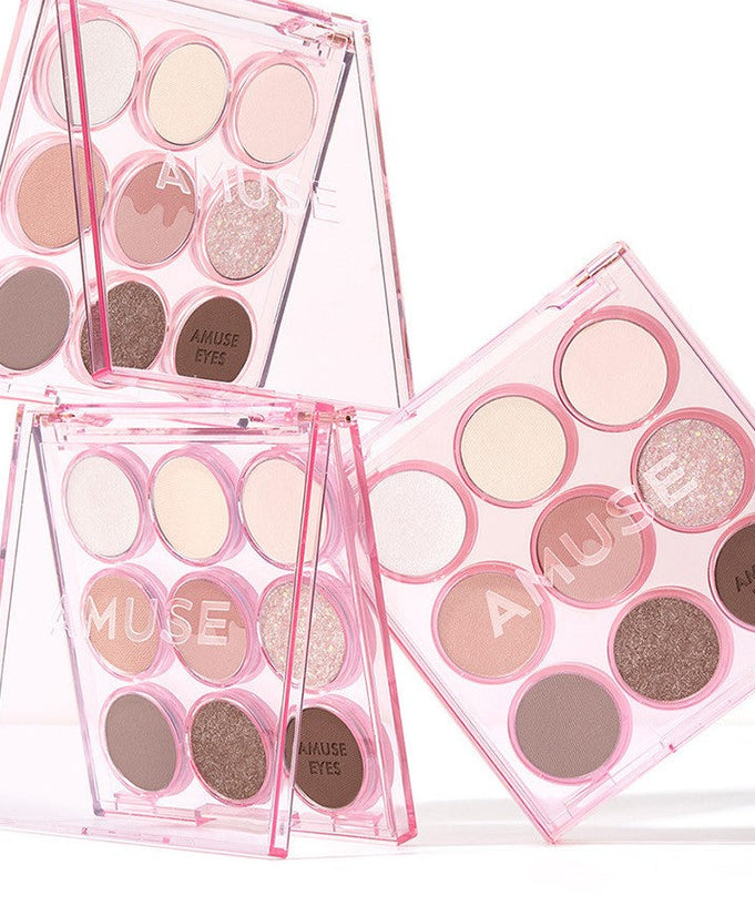 AMUSE Eye Color Palette featuring a variety of pink and neutral shades in a stylish pink case.