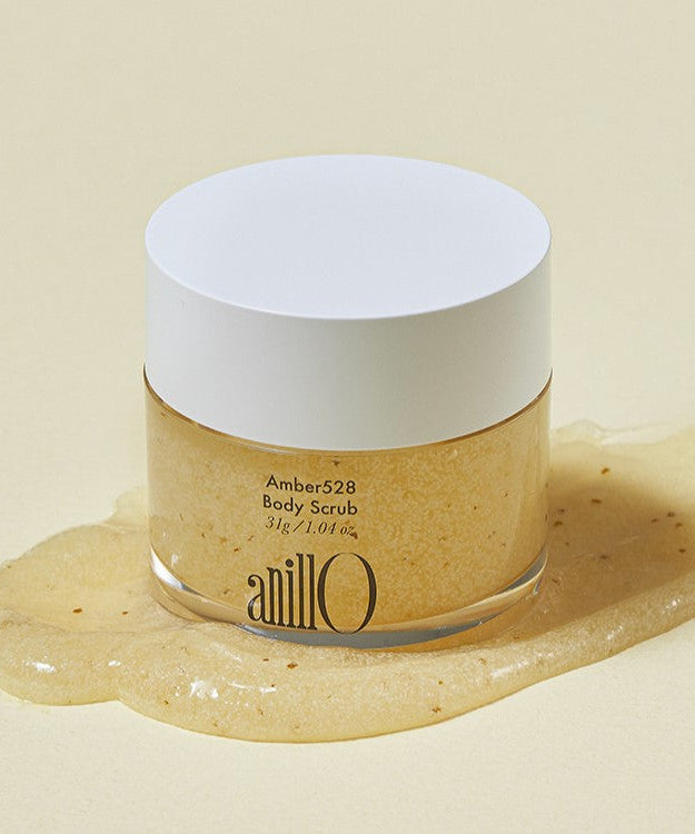ANILLO Amber528 Body Scrub 31g jar on spilled scrub background