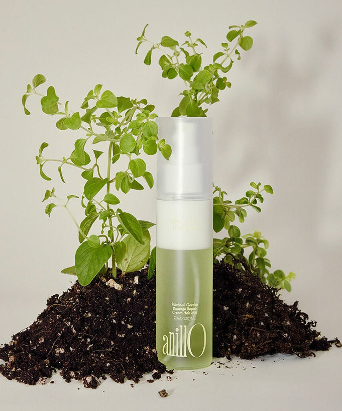 ANILLO Patchouli Garden Damage Repair Cream Hair Mist 70ml with natural ingredients displayed on soil and plants