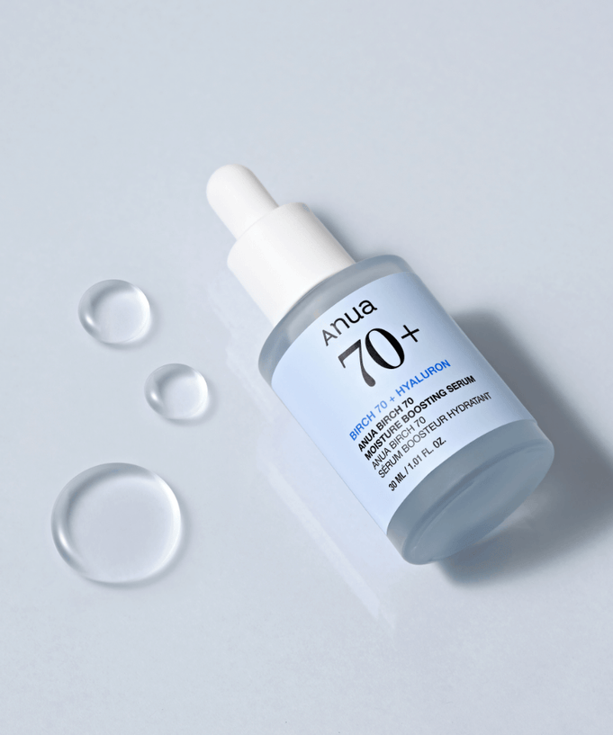 ANUA Birch 70 + Hyaluron Moisture Boosting Serum 30ml bottle with dropper on light blue background with droplets