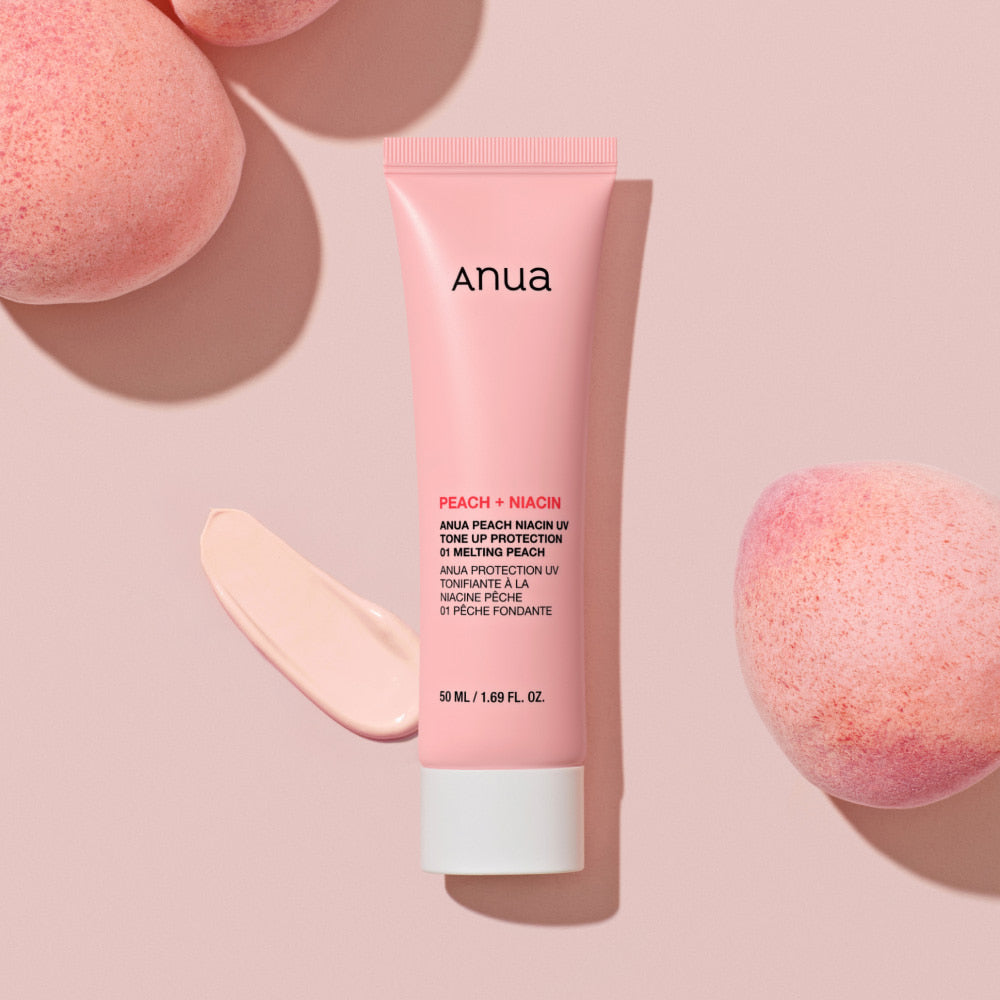 ANUA Peach + Niacin UV Tone Up Protection 50ml sunscreen tube on pink background with peach.