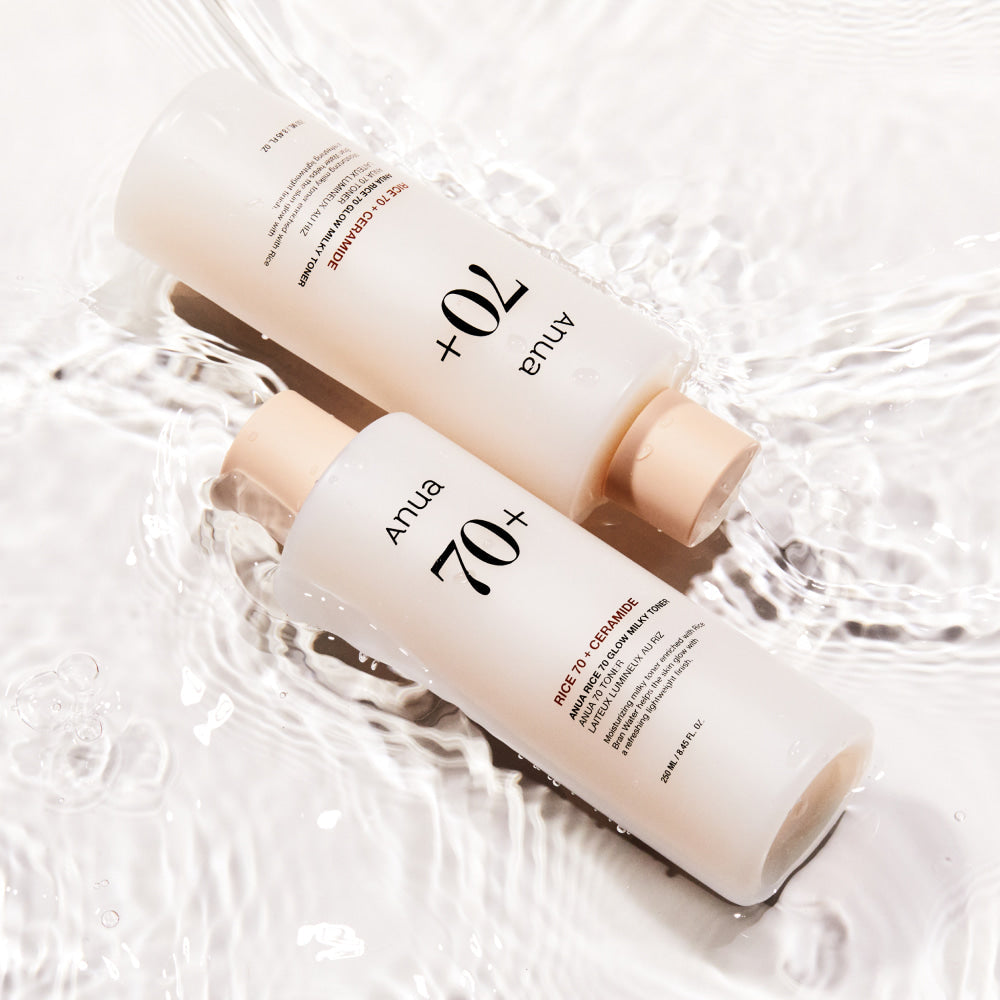 ANUA Rice 70 + Ceramide Glow Milky Toner 250ml bottles submerged in water