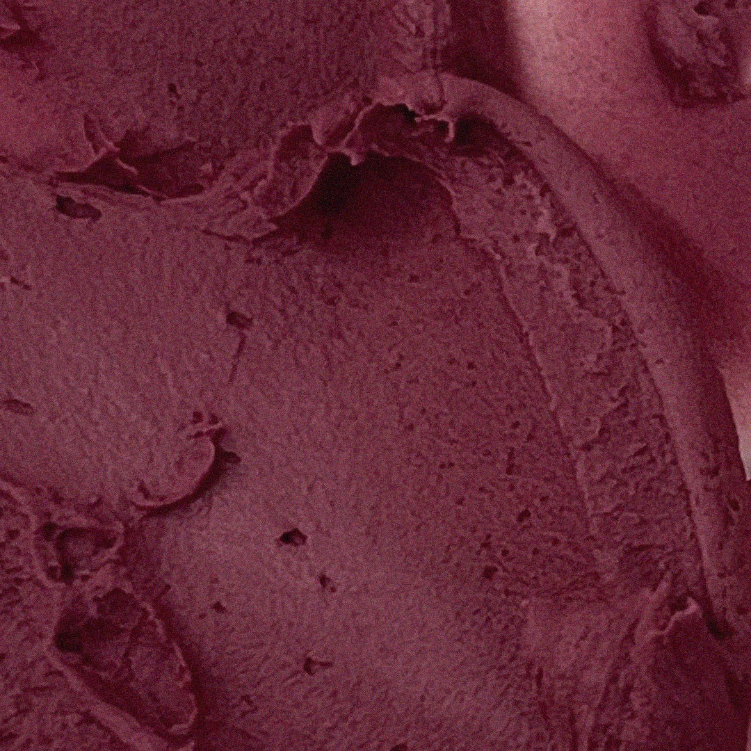 Close-up of AOU Floofy Matte Balm texture in rich burgundy shade.