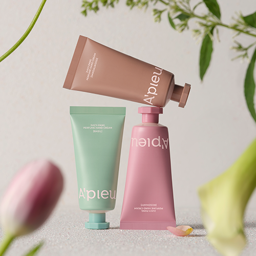 A'PIEU Juicy Pang Perfume Hand Cream 30ml assortment with pastel packaging and floral background