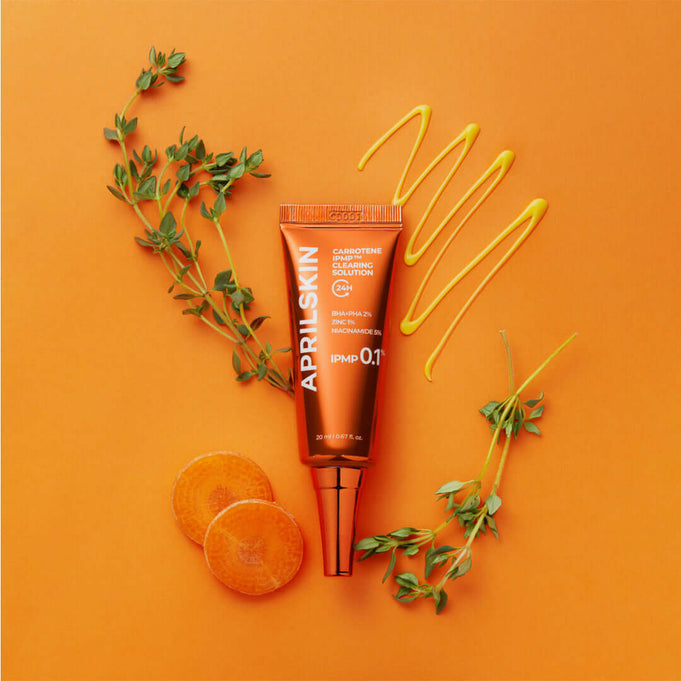 APRILSKIN Carrotene IPMP Clearing Solution with orange background and natural ingredients displayed