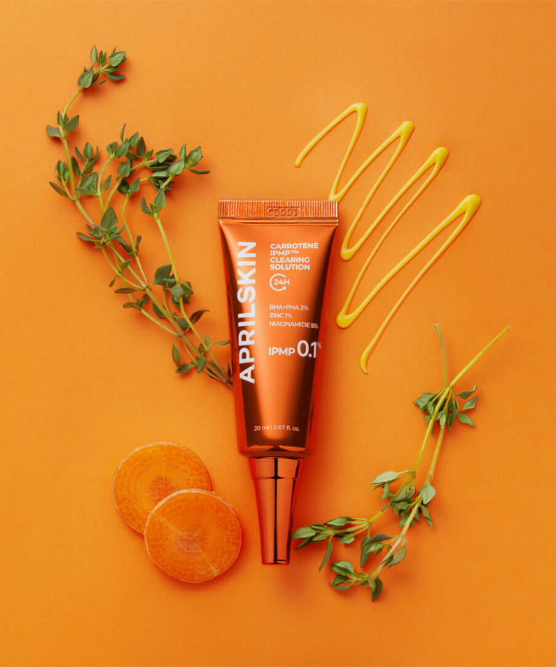 APRILSKIN Carrotene IPMP Clearing Solution with orange background and natural ingredients displayed