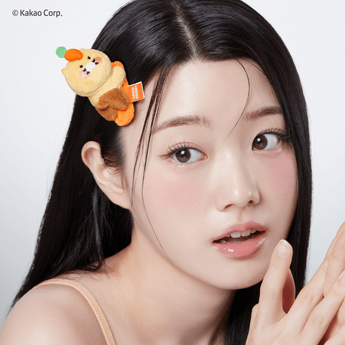 Woman wearing a hair accessory with a quirky character design, featuring a playful expression and vibrant colors.