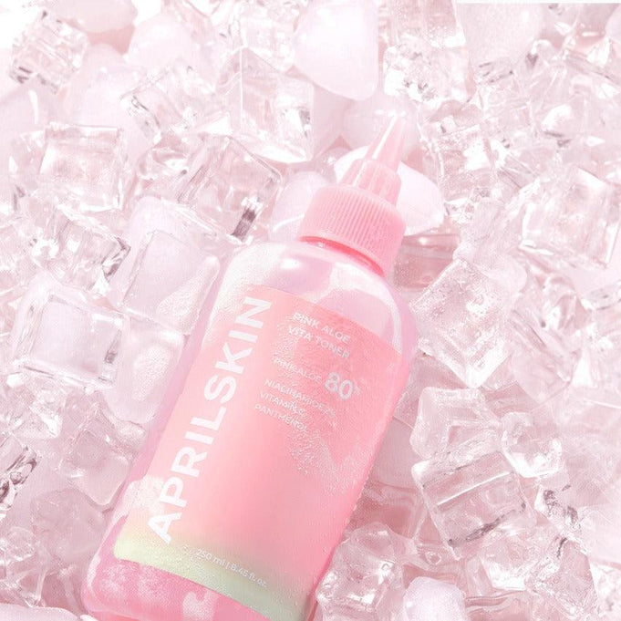 APRILSKIN Pink Aloe Vita Toner bottle surrounded by ice cubes, highlighting its refreshing and hydrating properties.