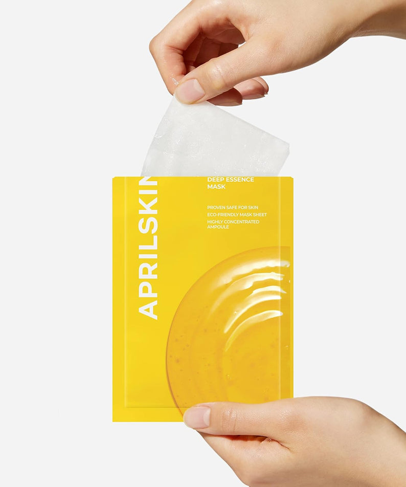 Hand holding APRILSKIN Real Calendula Deep Essence Mask in yellow packaging