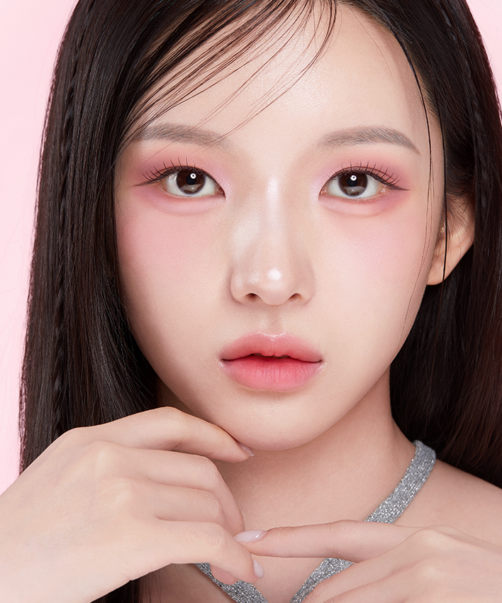 Portrait of a person with pink eyeshadow and smooth skin, illustrating the effects of APRILSKIN Slide Pocket Single Shadow.