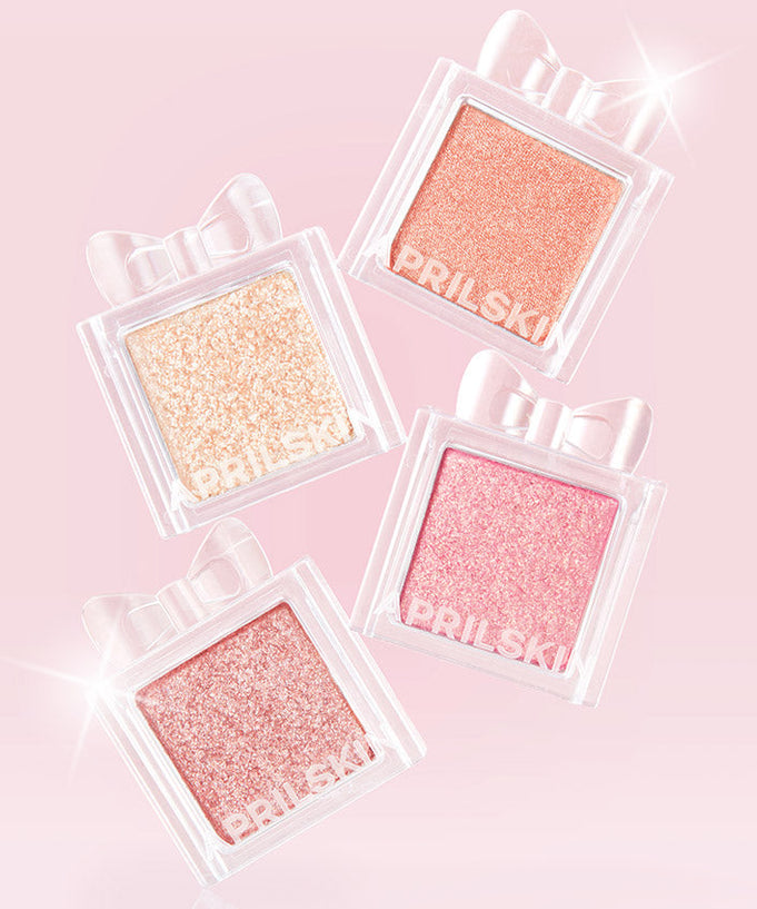 APRILSKIN Slide Pocket Single Shadow in four shimmering shades on a pink background, highlighting glimmer and elegance.
