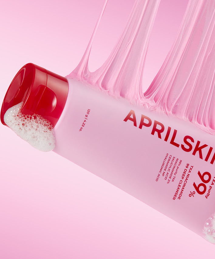 APRILSKIN TXA Niacinamide 99 Deep Cleanser 120g product packaging with foamy texture and pink background.