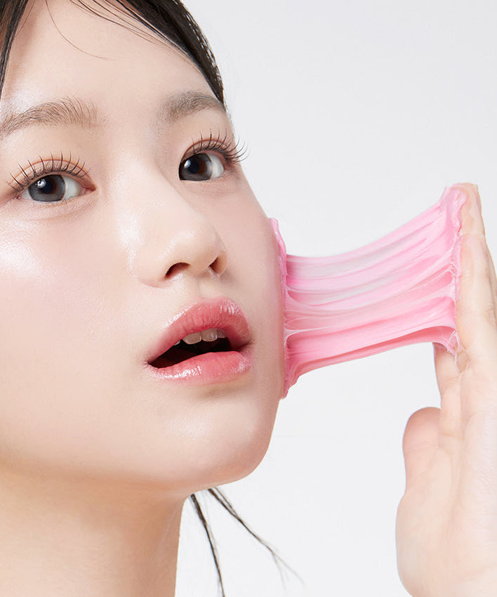 Woman using a stretchy facial cleanser mask, showcasing skincare routine with APRILSKIN TXA Niacinamide 99 Deep Cleanser 120g.