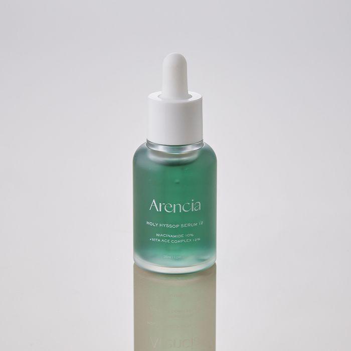 Bottle of ARENCIA Holy Hyssop Serum 12 30ml with white dropper on a reflective surface.