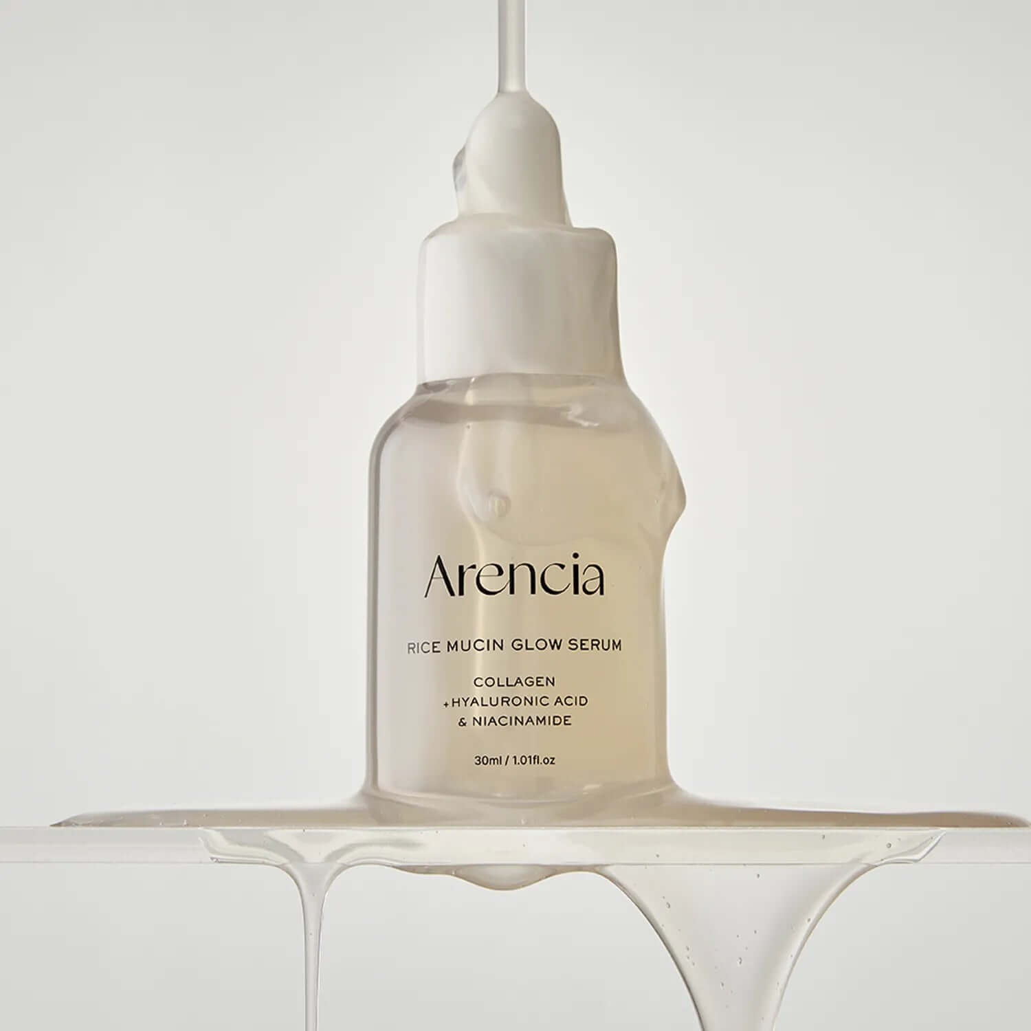 ARENCIA Rice Mucin Glow Serum 30ml bottle with dripping serum showcasing ingredients like collagen, hyaluronic acid, and niacinamide.