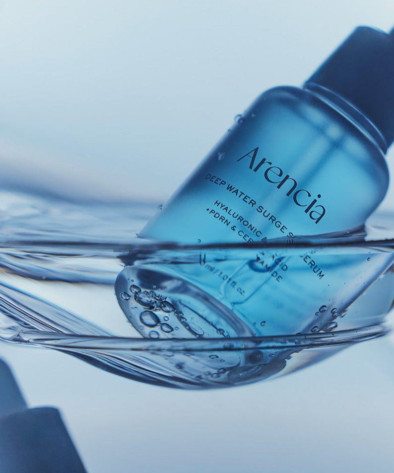 ARENCIA Deep Water Surge Serum 30ml bottle immersed in water, showcasing its hydrating properties.