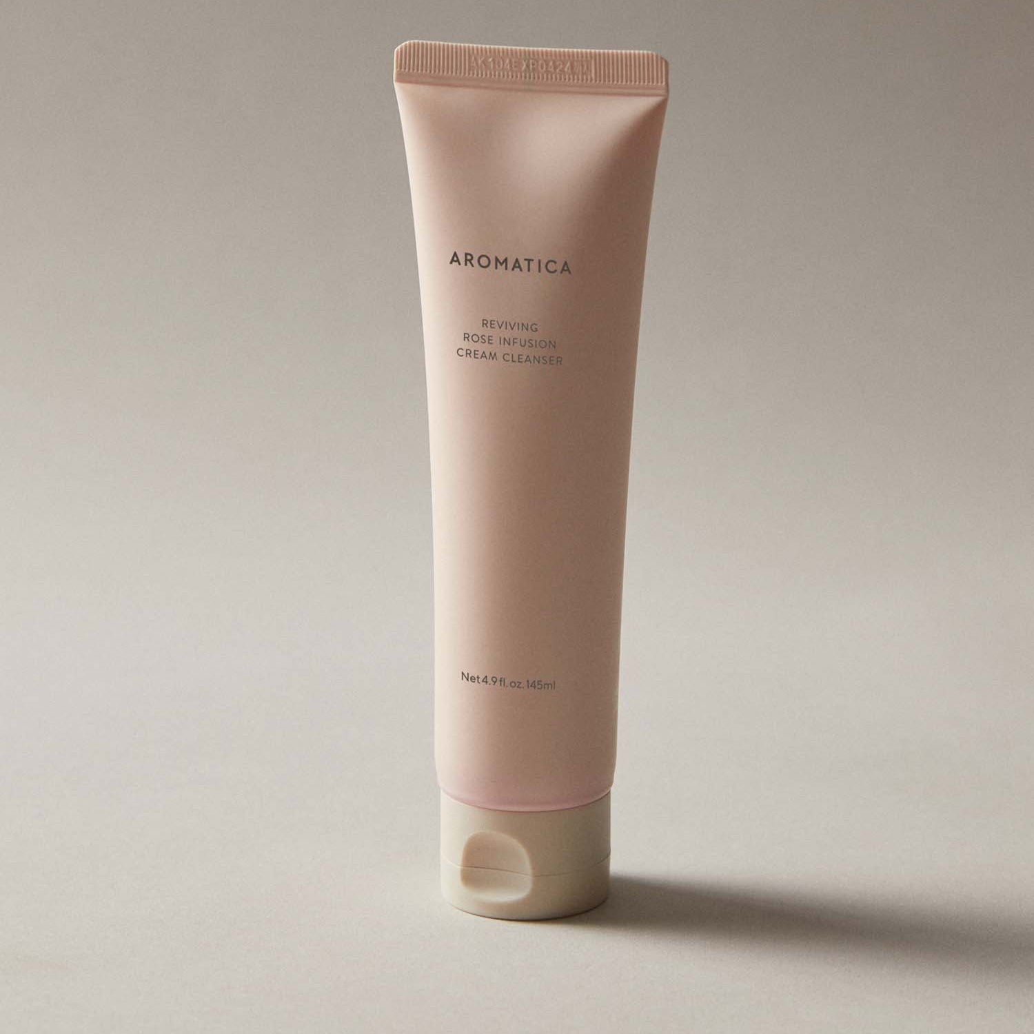 AROMATICA Reviving Rose Infusion Cream Cleanser 145ML in beige tube on neutral background