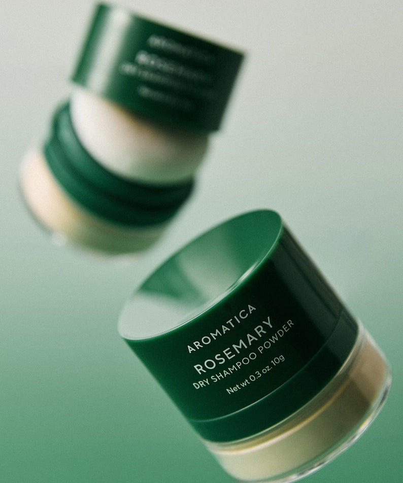 AROMATICA Rosemary Dry Shampoo Powder 10g in green jars against a gradient background